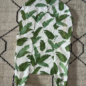 DockATot Deluxe+ dock in the "Bananas For You" leaf print cover